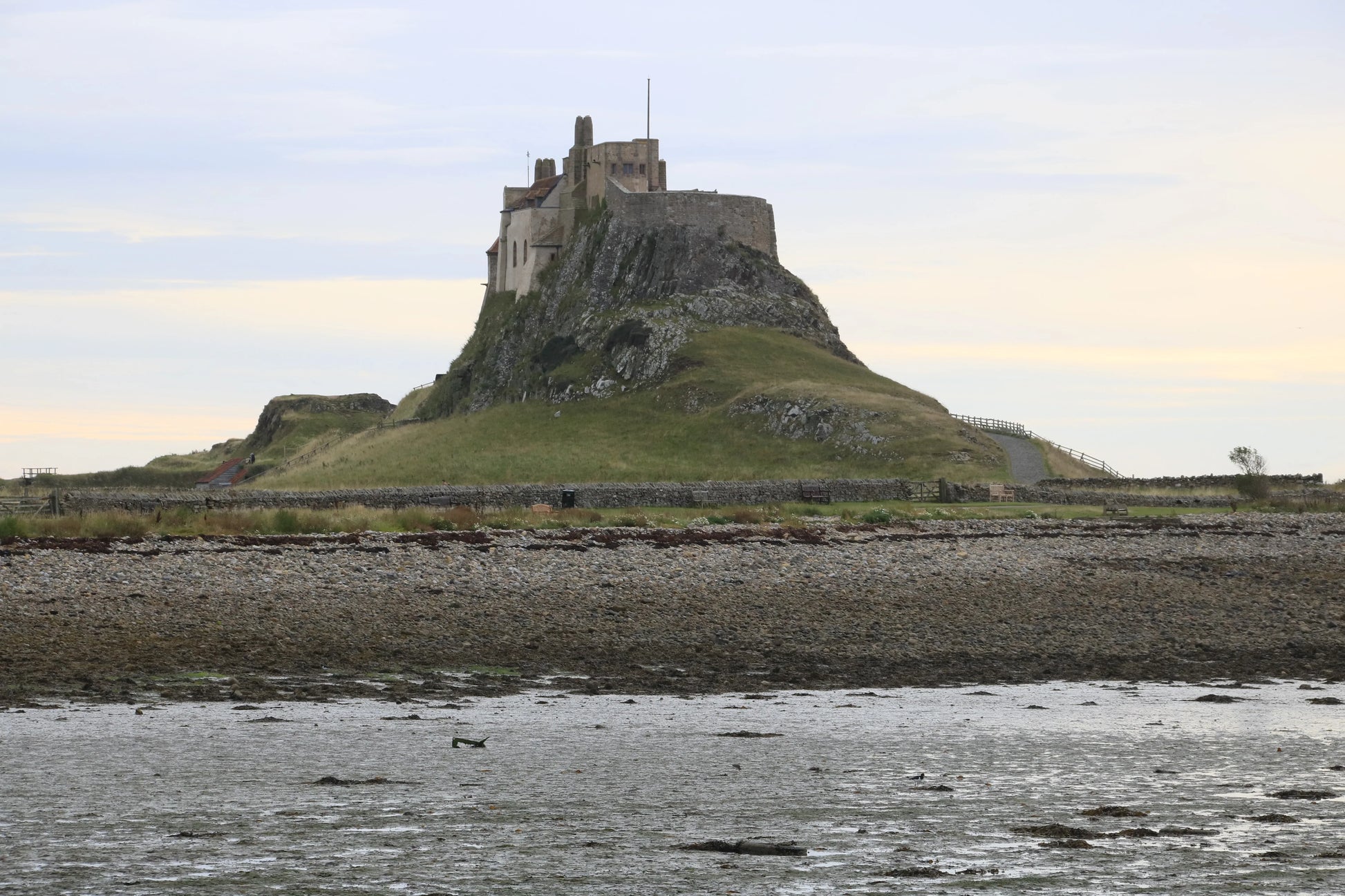 Lindisfarne Castle on rocky hill overlooking tidal shore in Northumberland, British landscape photography