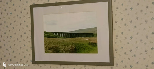 Framed landscape photograph of Ribblehead Viaduct in British countryside with green hills and cloudy sky