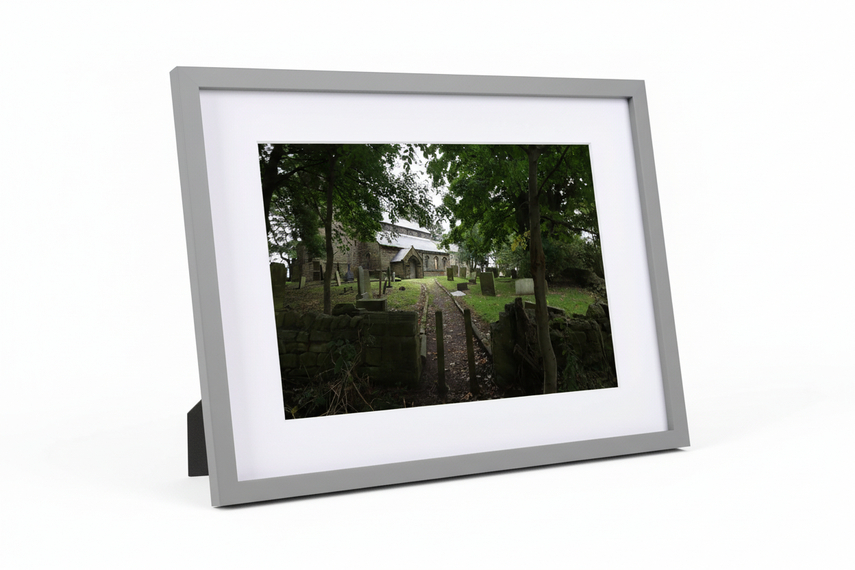Framed print of Alnwick church and graveyard pathway under leafy green trees, British landscape photography