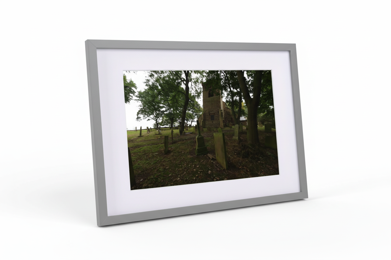 Framed print of Alnwick church tower surrounded by trees and old gravestones in a quiet graveyard