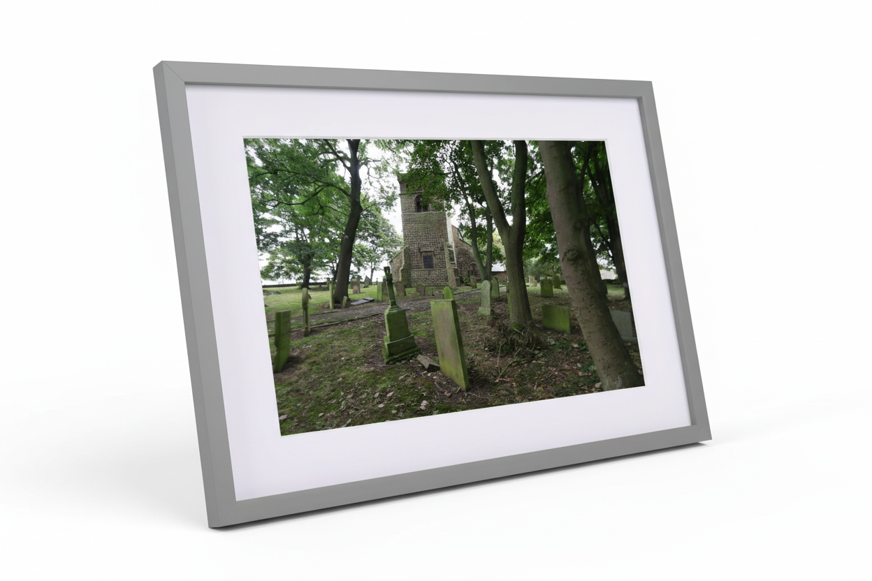 Framed print of Alnwick church surrounded by tall trees and old graveyard with weathered tombstones