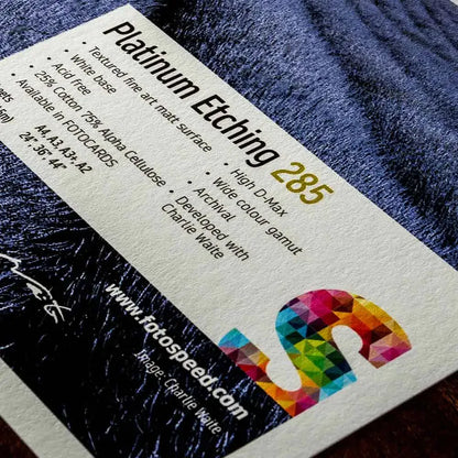 Close-up of Platinum Etching 285 textured fine art matte paper label with product features and colorful Fotospeed logo