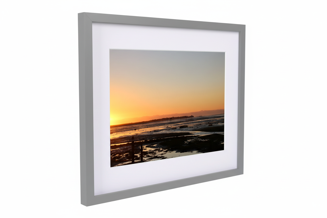 Framed fine art print of Lindisfarne Causeway sunset with tidal flats and warm orange sky