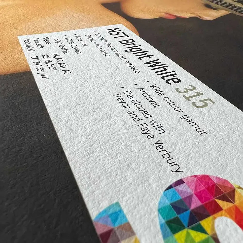 Close-up of NST Bright White 315 textured fine art paper label on a photography print