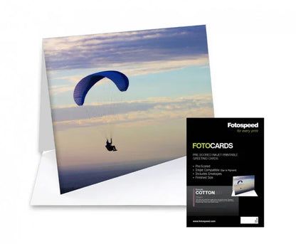 Fotospeed Smooth Cotton photo greeting card featuring a blue paraglider against a cloudy sky