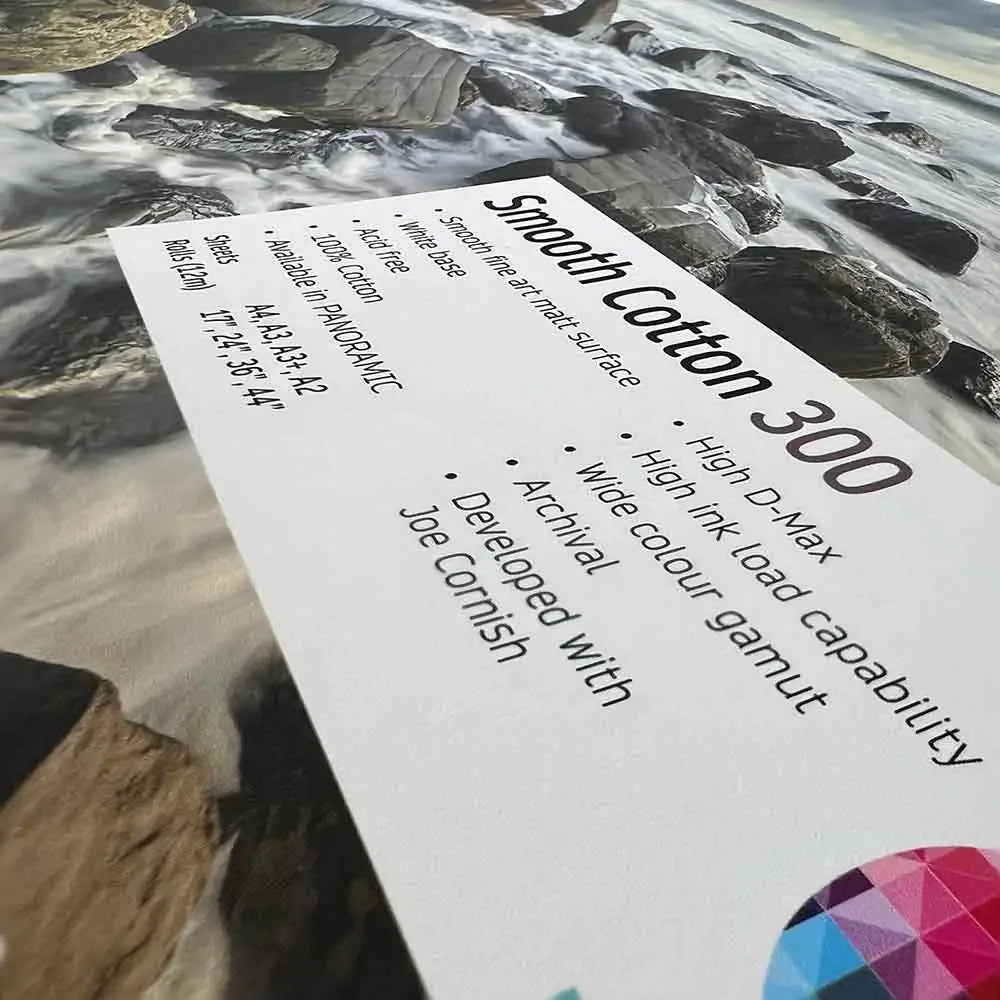 Close-up of Smooth Cotton 300 fine art paper sample on a rocky riverbed landscape print